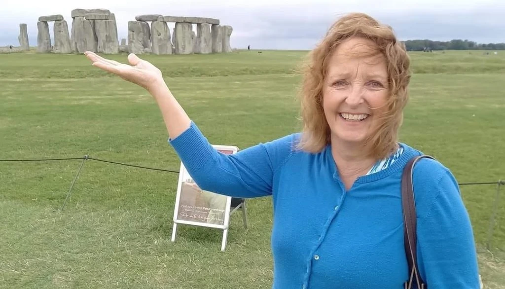 woman next to stone henge