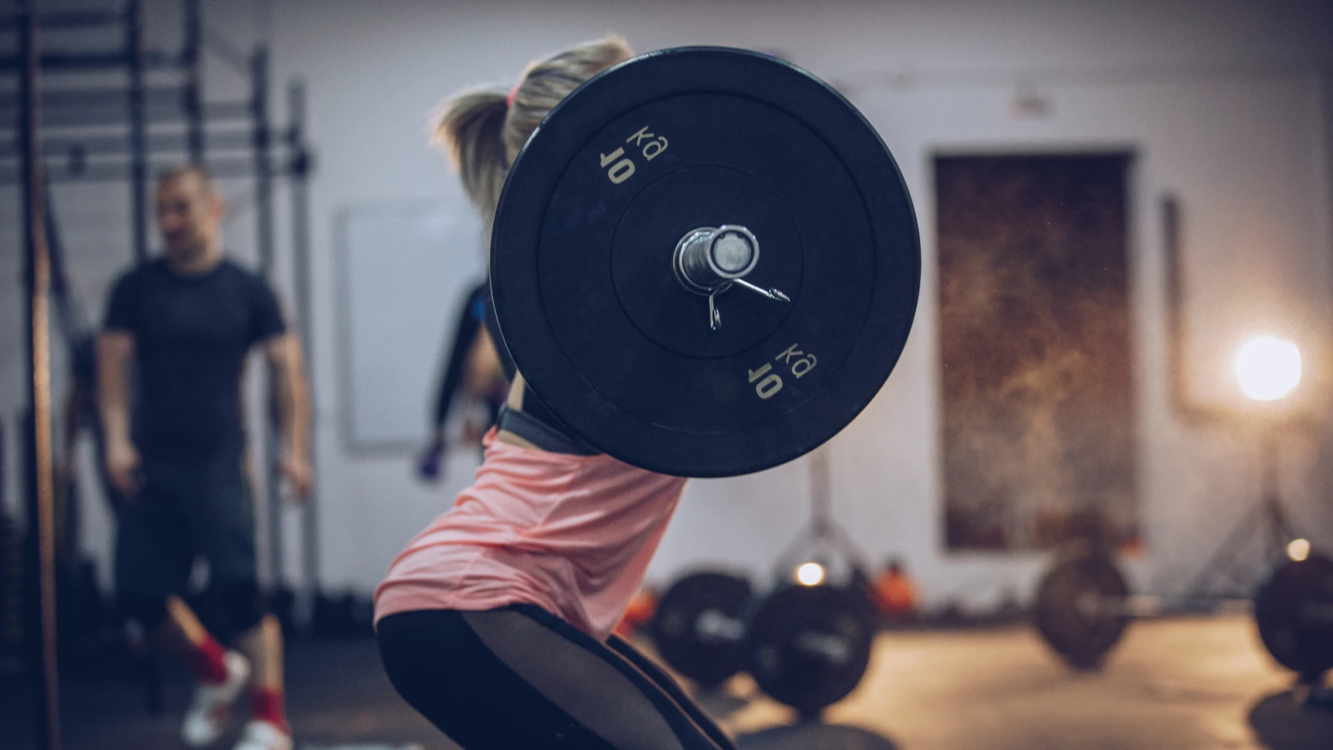 woman squatting in a gym